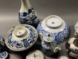 many blue and white vases and bowls on the table
