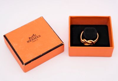 an orange box with a ring inside of it on a white surface