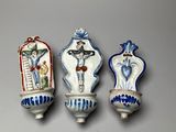 three decorative wall sconces with blue and white designs on them