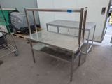 a metal table with a glass top in a room