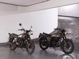 two motorcycles that are parked in a parking garage