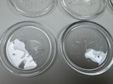 four clear plastic plates with different designs on them sitting on a table