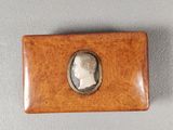 a small wooden box with a picture of a man on it