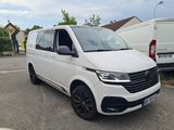 the white van is parked in the parking lot next to a white van