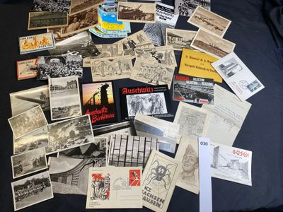 a lot of old postcards on a black table
