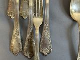 five forks and two spoons on a table