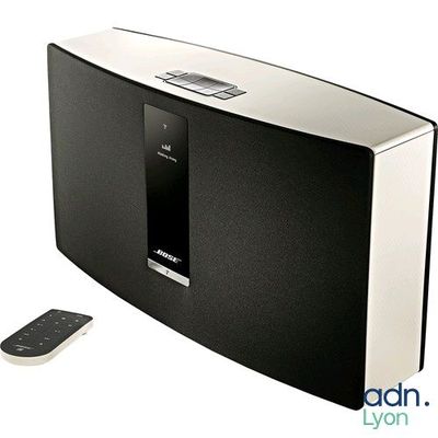 an image of a black and white speaker and a remote control
