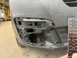 someone is measuring the front bumper of a car with a ruler