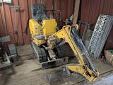 a yellow bulldozer that is parked in a garage