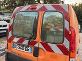an orange van that is parked in a parking lot