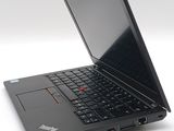 a black laptop computer sitting on a white surface
