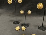 several pieces of jewelry are displayed on a black surface