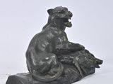 statue of a dog sitting on a rock on a white background