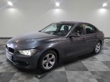 a picture of a gray bmw car in a garage