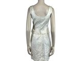 the mannequin is wearing a white dress with a floral pattern on it