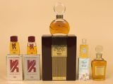 a bottle of perfume sitting on a table next to other bottles