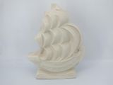 a white sculpture of a ship on a white background