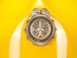 a police badge on the top of a yellow fire hydrant