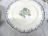 a white plate with blue and yellow flowers on it