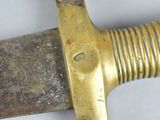 a close up of a knife on a white surface
