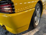 a yellow sports car parked on the side of the road