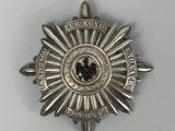 a close up of a badge on a white surface with a white background