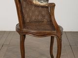 an image of a chair with a cushion on it in a room