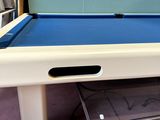 a pool table with a blue cloth on it