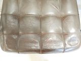 a brown leather chair that is sitting on the floor