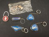 a lot of keychains that are sitting on a table