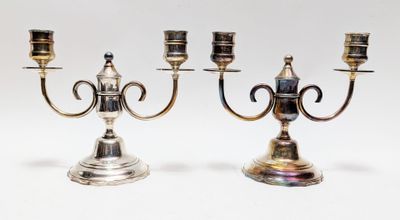 pair of silver plated candlesticks on stands on a white background