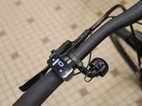a close up of a bike with a clock on the handlebar