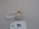 a white tag with a gold ring on it and a white tag with a gold ring on it