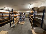 a large room with shelves and pallets in it