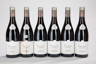 six bottles of wine are lined up in a row on a table