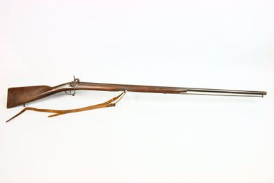 an old rifle on a white background with a wooden handle