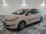a picture of a white car parked in a garage