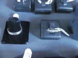 many different types of jewelry on display on a table