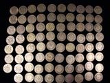 some silver coins are arranged in a square on a black surface