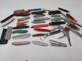 many different types of pocket knives on the table