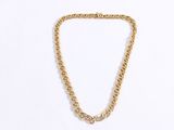 a close up of a gold chain necklace on a white background