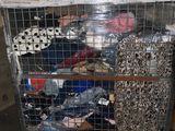 a cart full of clothes sitting in a warehouse