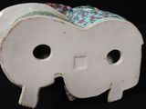 a white elephant figurine with a floral design on it ' s head