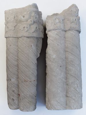 two pieces of stone that are sitting on a white surface