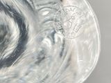 a glass vase that has a flower inside of it