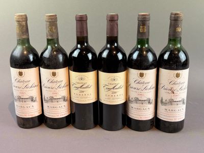 six bottles of wine are lined up in a row on a table