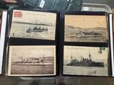 four old photos of ships in a book on a table