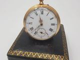 a small black box with a gold clock on top of it
