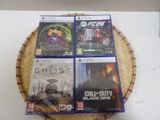 four video games are on a basket on a table