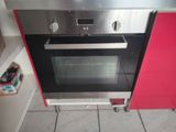 an oven that is built into the wall in the kitchen
